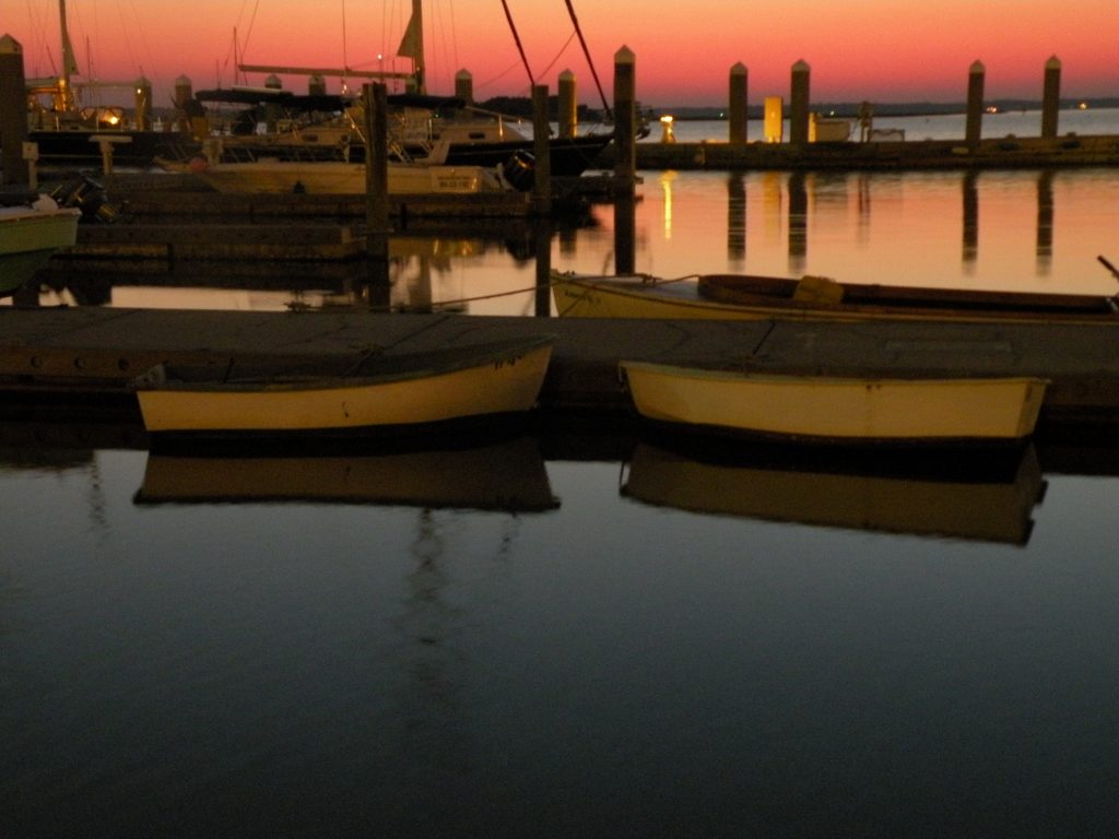 boats in harbor at sunset