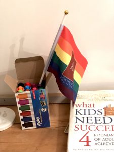 Markers, small pride flag and book in office