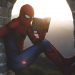 Spider-Man leaning on concrete brick while reading book