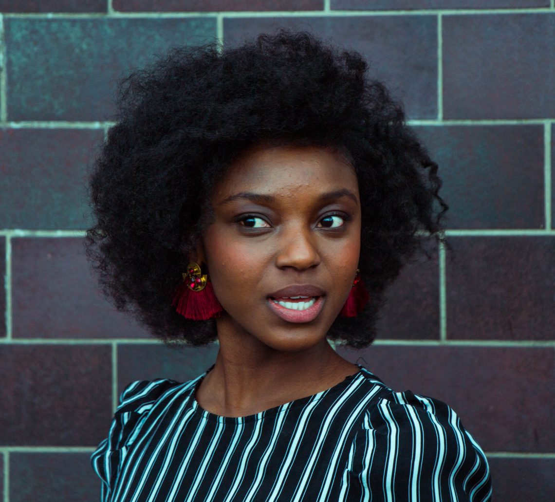 woman wearing black and green top