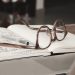 eyeglasses with gray frames on the top of notebook