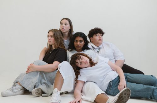 women and man sitting on floor