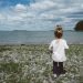 girl standing on seashore during daytime