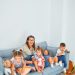 3 women sitting on gray couch