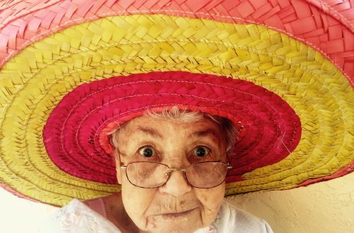 woman using eyeglasses and wearing hat