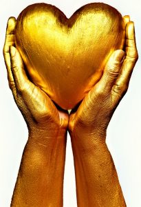 Gold hands holding grateful heart